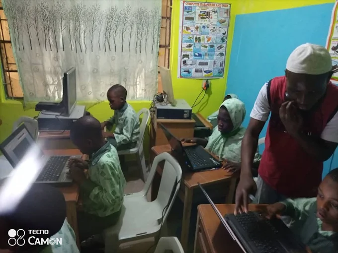 Teacher guiding pupils in the computer room
